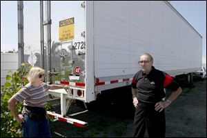 Sgt. Karen Sue Martensen, president of the police museum board, and her husband, retired Toledo police Detective Gene Fodor, check on the trailer where artifacts are stored. Sergeant Martensen and officers like her have gathered the items over the years because they value the department's rich history.