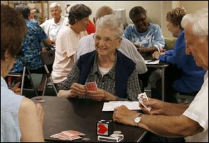 Julia Kotowicz, center, plays cards with friends at the Zablocki Senior Center on Lagrange Street in Toledo, a designated cooling center for area seniors seeking relief from the heat wave.
