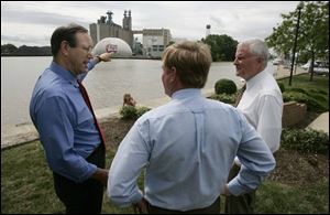 Gov. Bob Taft, left, joins Steve Gray, center, and Sam Speck of the Ohio Department of Natural Resources along the Huron River. The state helped Huron acquire the site.