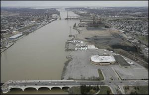 The Marina District sits on the east bank of the Maumee River. The large structure at center right is the Sports Arena.
