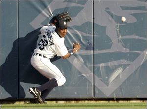 Tigers center fielder Curtis Granderson chases down a ball hit off the wall by Jermaine Dye of the White Sox. 