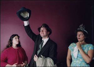 Elwood P. Dowd (Steve Copps) places a hat on his invisible friend, Harvey, as niece Myrtle, left
(Britney Koser) and sister Veta (Heather Williams) react in a scene from Harvey.