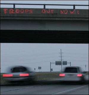Mike Ferner and his brother, John, were arrested after anti-war slogans were spray-painted on two area bridge overpasses.