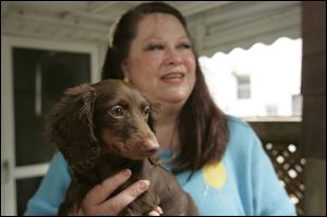 Carol Parcell holds Ruby, a 4-month-old minature dachshund.