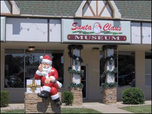 Santa welcomes visitors to the Santa Claus Museum, in Kringle Plaza in Santa Claus, Ind.