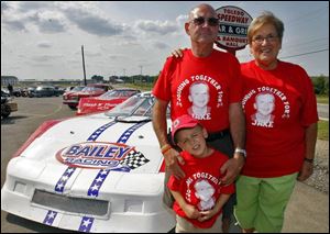 FOR JAKE'S SAKE: Jake Block, 4, stands with Pete Bailey, left, and Jake's grandmother Pat Boes, at the Toledo Speedway Bar and Grill.