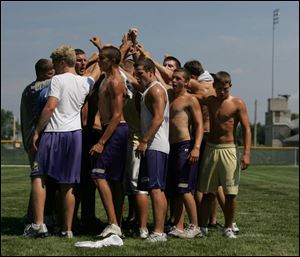 Maumee football players huddle up after a 30-minute workout. Strenuous activity, such as football conditioning drills, and summer heat can be a dangerous combination. 
