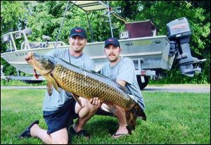 Jake Kerstetter, left, of Springboro, Ohio, and Gary Fogle of Canal Fulton, Ohio, hold Kerstetter's carp taken with bow and arrow at Port Clinton. The 43-inch carp weighed 40.25 pounds. 