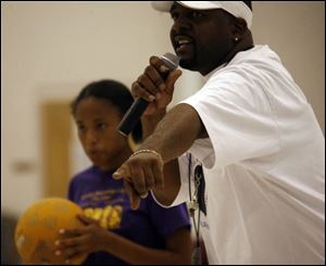 Coach Anthony Johnson calls a player out, above, during a kickball game at Bethlehem Baptist Church. The games are one way parents are making up for the cuts in funding to youth programs. 