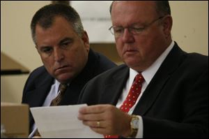 Tom Noe, left, and attorney Bill Wilkinson listen in court. An investigator testified yesterday that he was given bogus documents at Noe's Monclova Township business. STORY, PAGE 3.