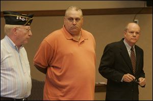 Post 441 member Tom German, left, speaks to the court before the sentencing of Roger Glasgow, who stole post funds.