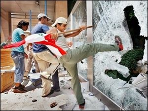 Hezbollah supporters furious over an Israeli airstrike in Qana attack the UN building in Beirut today.