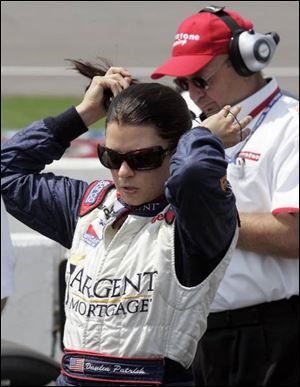 Danica Patrick tidies up after qualifying 11th for today's race. Next season, she'll be qualifying in Michigan as a member of Andretti Green Racing.
