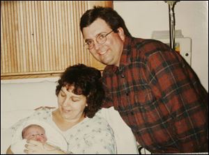 Michael Luebrecht, with wife Amy after Joel's birth in 2004, was sentenced to at least 25 years.
