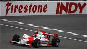 Helio Castroneves pumps his fist after winning the Firestone Indy 400 at Michigan International Speedway.
