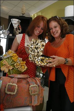 PURSE PASSION: Alexandra Martin and her mother, Mary Martin, peruse the purses at the YMCA auction.