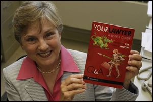 Susan Martyn holds a copy of her book.