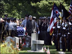 The casket of Holland Police Chief Doug Kaiser is guided into Springfield Township Cemetery following the chief s funeral in Springfield High School s auditorium. Chief Kaiser, who ended his life after a police chase July 28 in Sidney, Ohio, was eulogized as a man who was willing to help others through tough times. 