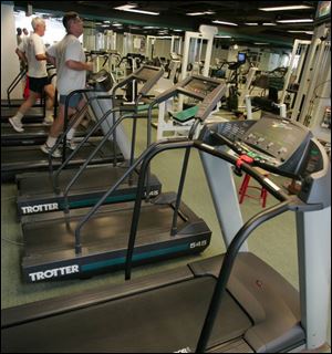 Most treadmills are empty on the last day for the small gym in the basement of the office tower. 
