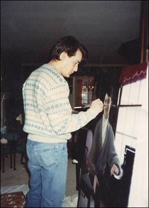 Chris Kohli works on a portrait at his easel. Some works of the artist, who died Feb. 12, are on display at Bluffton University.