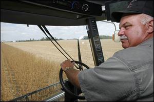John 'Cash' Young harvests soybeans on his farm near Bowling Green in Wood County.