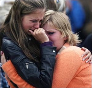 Sophomores and friends Taylor Fraser, 15, left, and Sophie Sasser, 15, hug after being reunited after the hostage siege at the school.