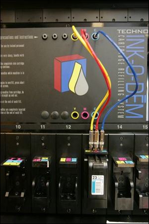 Tubes plug into ports to deliver the ink colors.