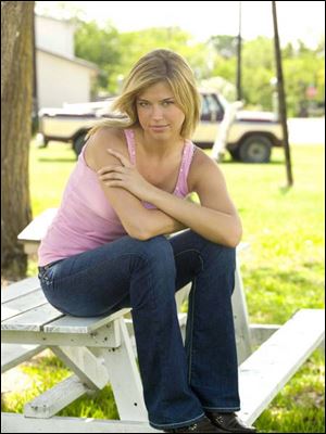 Adrianne Palicki in the new NBC series <i>Friday Night Lights</i>. When Palicki began landing television roles, her mother, Nancy, turned to Kathy Holmes (Katie's mother) for advice.
