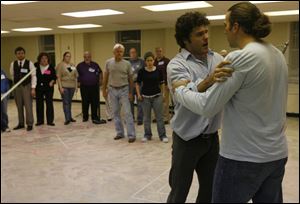 Lee Gregory, left, and Eric Fennell rehearse a scene of Toledo Opera's production of <i>Romeo and Juliet</i>.