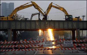 Crews work to remove the  River East  railway bridge, which required temporary closing of
Main Street. The overpass had once carried trains of the Pennsylvania Railroad.
