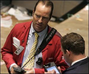 Specialists work the trading floor at the New York Stock Exchange a short time before the closing bell Tuesday. 