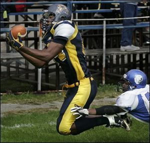 Whitmer tight end Kevin Koger makes a touchdown catch against Woodward. The 6-4, 220-pound junior, who has already received a scholarship
offer from the University of Toledo, has 13 receptions for a team-high 230 yards and three TDs. As a defensive end, he has 23 tackles.
