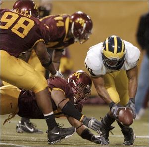One of the few plays on which Michigan running back Mike Hart, right, didn't gain yardage was this fumble vs. Minnesota.