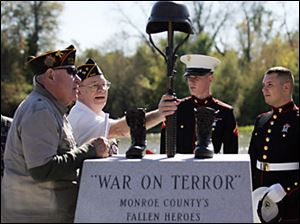 Richard Pearch and William Payne join Marines at a new memorial in Veterans Park for troops killed in Iraq and Afghanistan. 