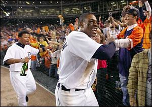 Curtis Granderson, right, and Ramon Santiago celebrate their 8-3 win over the New York Yankees that put the Tigers into the American League championship series with Oakland.