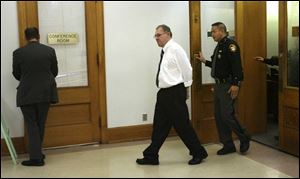 Danny Anaya leaves the courtroom at the Lucas County Courthouse, where his murder trial began yesterday.