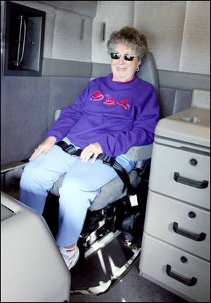 Daisy Roper sits in the back of a semi-truck.