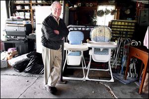 Forest Kosch shows some of the donated items that he has stored in his Maumee garage for distribution to the needy.