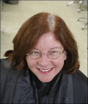 Kathy Luce in a 'before' photo showing gray hair growing out of previously colored hair.