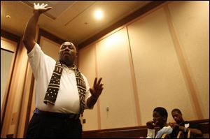 Alfred 'Coach' Powell speaks to a group of teenagers during the Man Up project conference at the Wyndham Hotel.