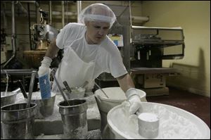 Near the beginning of the process, Jeff Roddy mixes flavoring ingredients. 