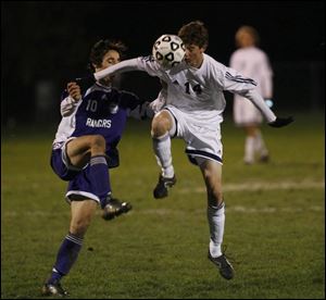 St. John's Mark Witherell, left, and Lakewood's Veton Esati fight to gain control of the ball last night in a Division I regional soccer semifinal at Huron. St. John's won the game and will take a 12-6-3 record into Saturday's regional final against Strongsville, which defeated Perrysburg 3-0 last night at Medina.