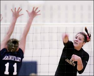 Perrysburg s Chelsea Campbell gets a kill over Rocky River Magnificat s Kristen DuBroy. The Yellow Jackets outlasted Magnifi cat 25-22, 17-25, 25-21, 27-29, 15-13. 
