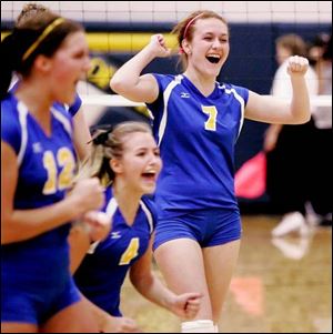 St. Ursula Academy s Hailey Marvin, left, Molly McCabe, center, and Kristen Sheely celebrate their victory over Elyria.
