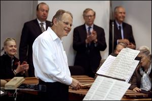 Robert Bell is applauded during his informal percussion recital.