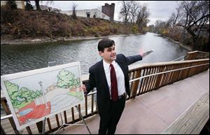 Joe McNamara, at-large council candidate, details his plan along the bank of Swan Creek.
