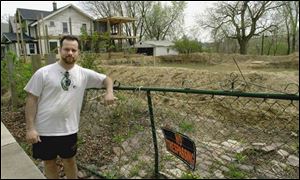 Rick VanLandingham leans on a fence in 2002 near his Paxton Street home. He was found guilty yesterday of tampering with records and forgery and pleaded no contest to assault.