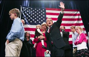 Republican Sen. Mike DeWine, surrounded by family including his wife, Fran, by his side, waves to supporters during his concession speech at GOP headquarters in Columbus.