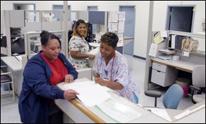 From left, medical personnel Temple O'Brien, Tamara Mills, and Myrtle Sparks work at the nurses' station at Cordelia Martin Community Health Center, which will move next year.