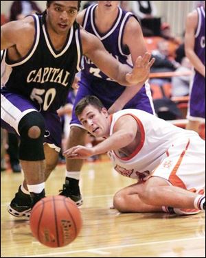 With Bowling Green's Matt Lefeld on the Anderson Arena floor, Capital's Steve Kyser, a Southview grad, goes after the basketball. Kyser scored 10 points to share high-scoring honors for the Crusaders in the exhibition game last night.